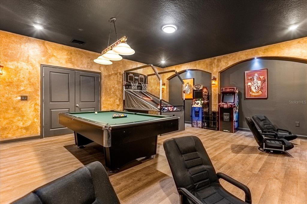 A game room features a pool table, arcade games, a basketball hoop, and black ceilings — 2931 FABLE STREET, KISSIMMEE, FL