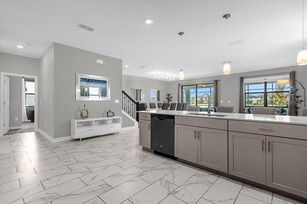 A kitchen with a large island, gray cabinets, and white marble-look tile flooring — 2931 FABLE STREET, KISSIMMEE, FL