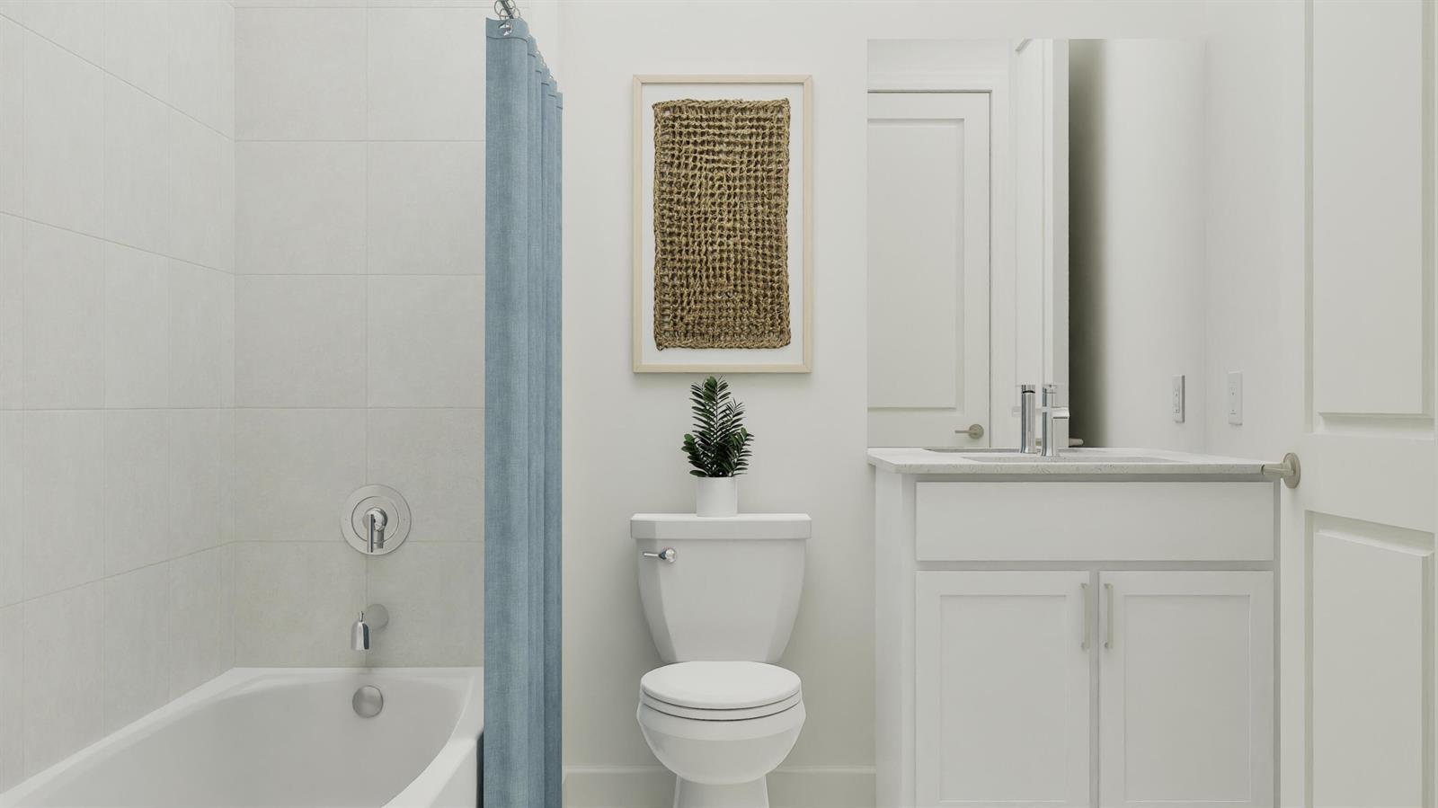 A bathroom features a white vanity, a toilet, and a bathtub with a blue shower curtain — 1014 Raleigh Way, Wellington FL 33414, WELLINGTON, FL