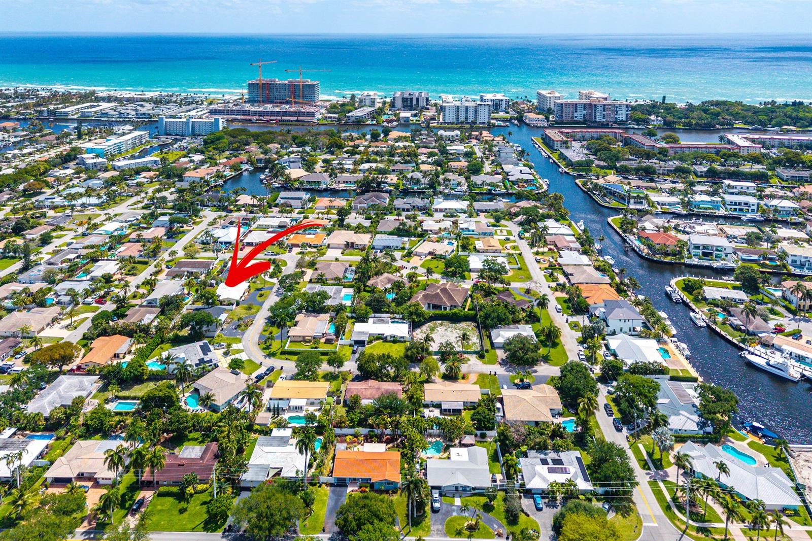 An aerial view of a residential neighborhood with a red arrow pointing to a house — 2741 NE 52nd Street, Lighthouse Point FL 33064, LIGHTHOUSE POINT, FL