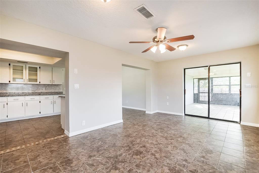 A dining area with tile flooring, a ceiling fan, and a sliding door to a patio — 2072 DUMAS DRIVE, DELTONA, FL