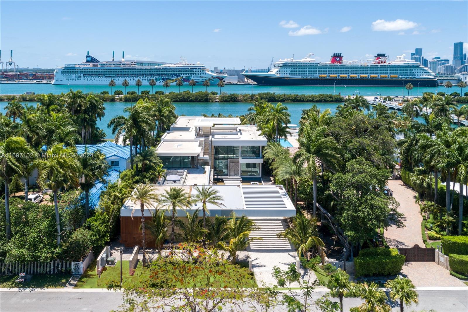 An aerial view shows a modern multi-story house with a flat roof and palm trees — 130 Palm Ave, Miami Beach FL 33139, MIAMI BEACH, FL