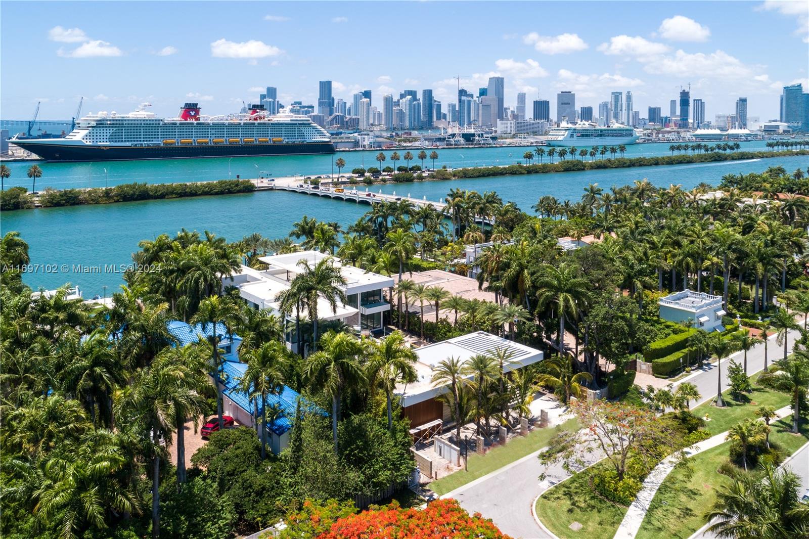 An aerial view of a waterfront property with palm trees, modern houses, and cruise ships — 130 Palm Ave, Miami Beach FL 33139, MIAMI BEACH, FL