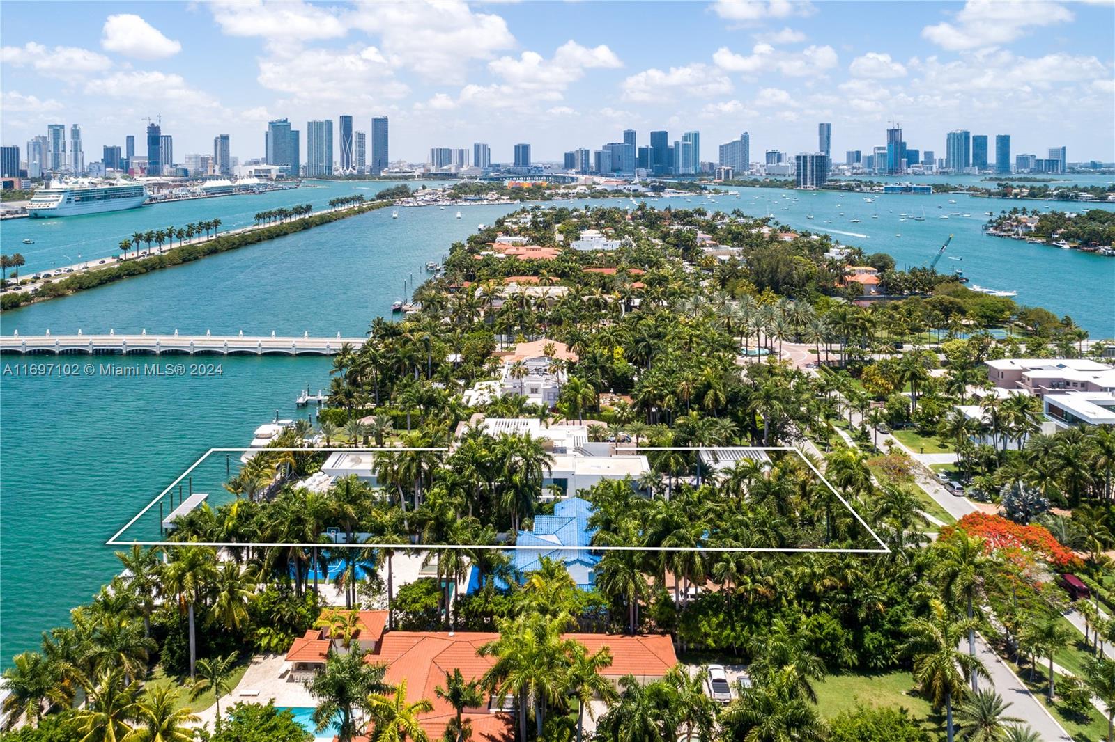 An aerial view shows a waterfront property with a white outline on a tropical island — 130 Palm Ave, Miami Beach FL 33139, MIAMI BEACH, FL