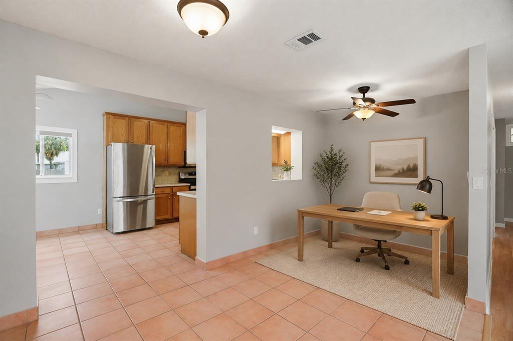A home office area with a desk and chair sits adjacent to a tiled kitchen — 4307 W WISCONSIN COURT, TAMPA, FL