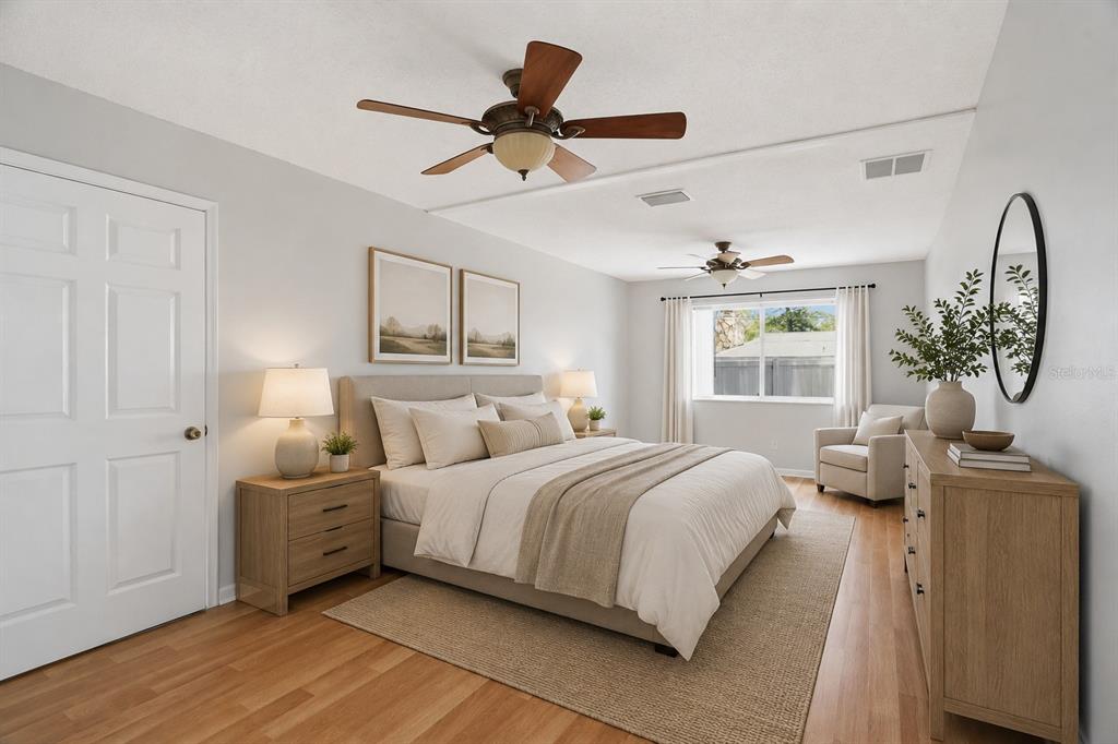 A bedroom features a queen bed, two nightstands, a dresser, and two ceiling fans — 4307 W WISCONSIN COURT, TAMPA, FL