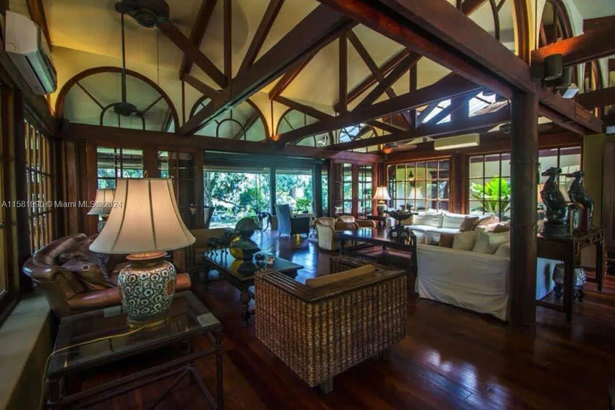A spacious living room features dark wood vaulted ceilings, exposed beams, and large glass windows — 9 Santa Rita de OROTINA Casa de Campo Costa Rica., Al, Al