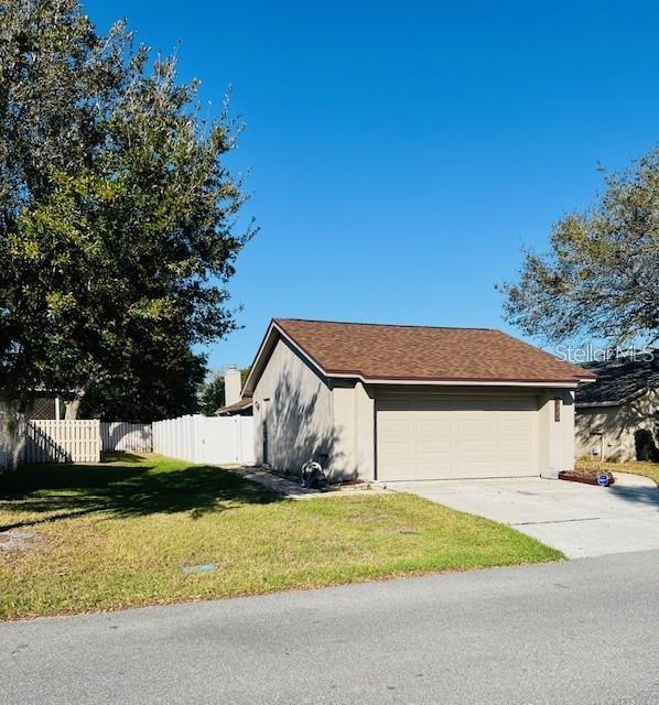 A detached garage with a brown shingled roof sits on a grassy lot — 1422 SPALDING ROAD, WINTER SPRINGS, FL