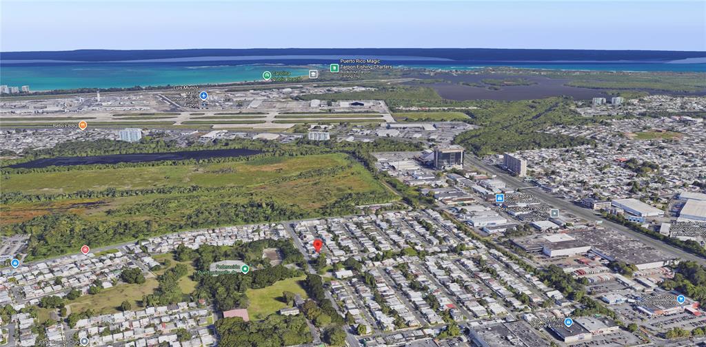 This aerial view shows a residential neighborhood near an airport and coastal wetlands — 5 Calle 519 QB6 URBANIZACIÓN COUNTRY CLUB, CAROLINA, PR