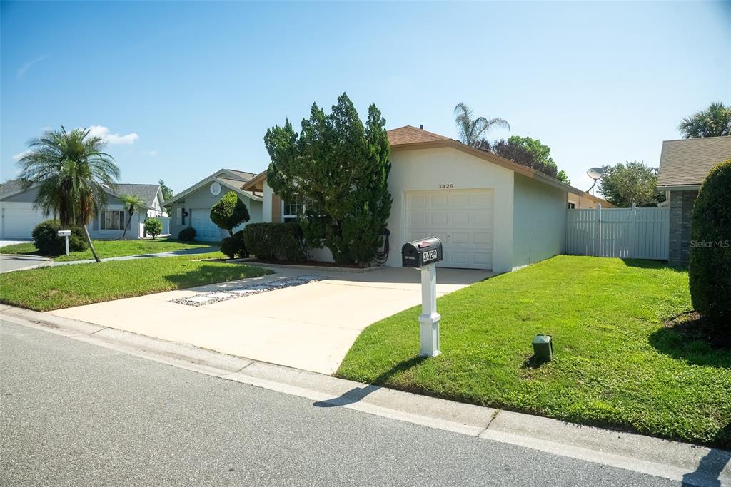 A single-story house with a white garage, a concrete driveway, and a front lawn — 3429 PINEBROOK COURT, ORLANDO, FL