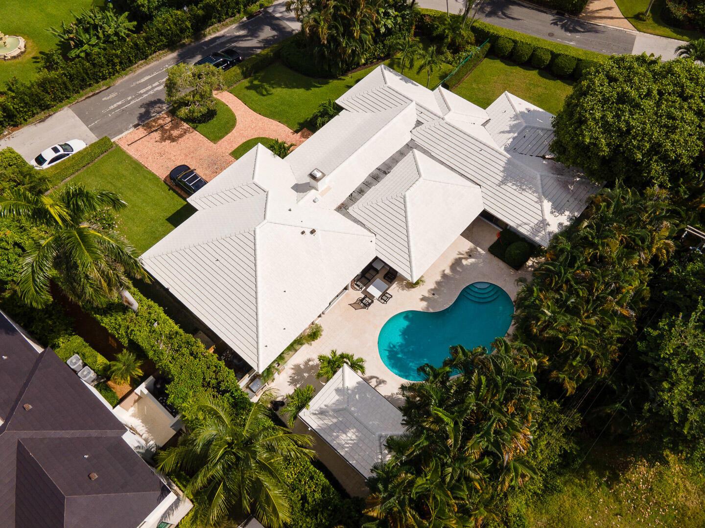 An aerial view shows a white-roofed house with a swimming pool and lush landscaping — 202 Coral Lane, Palm Beach FL 33480, PALM BEACH, FL