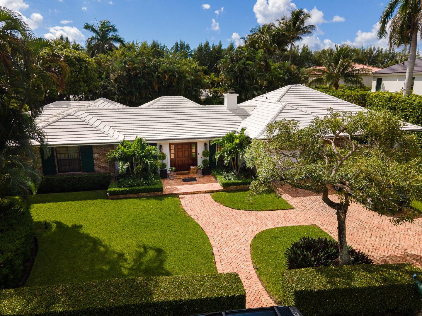 An aerial view of a single-story house with a white tile roof and brick walkway — 202 Coral Lane, Palm Beach FL 33480, PALM BEACH, FL