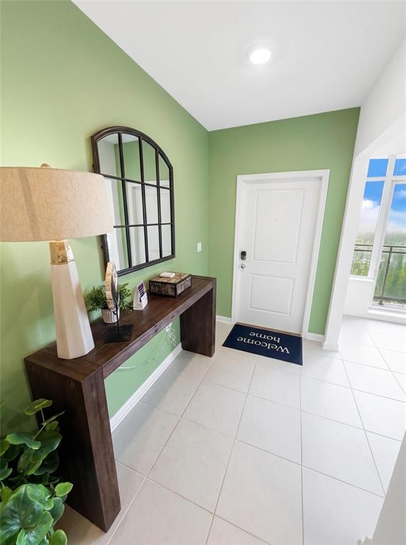 An entryway features a wooden console table, a wall mirror, and green painted walls — 1363 BLUE ASH LANE, DELAND, FL