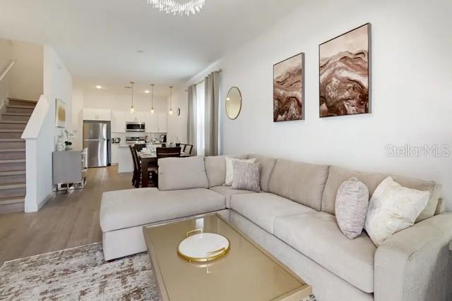 A living room features a large sectional sofa, a coffee table, and an open kitchen — 213 FAMAGUSTA DRIVE, DAVENPORT, FL