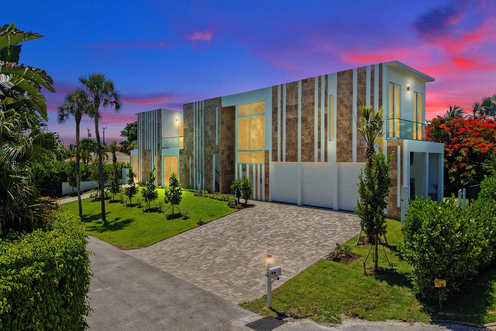 A modern two-story house with stone-accented facade, a paved driveway, and a lush green lawn — 824 W Marbella Lane, Lantana FL 33462, LANTANA, FL