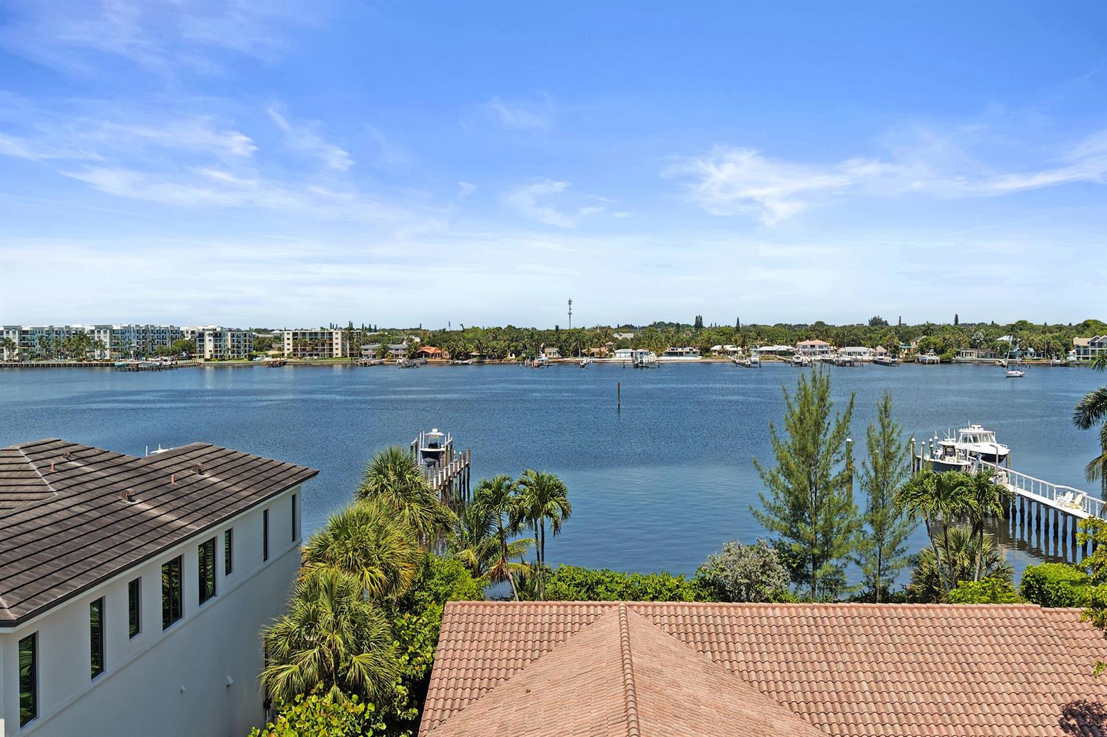 An elevated view of a waterfront property featuring a canal, private docks, and neighboring homes — 824 W Marbella Lane, Lantana FL 33462, LANTANA, FL