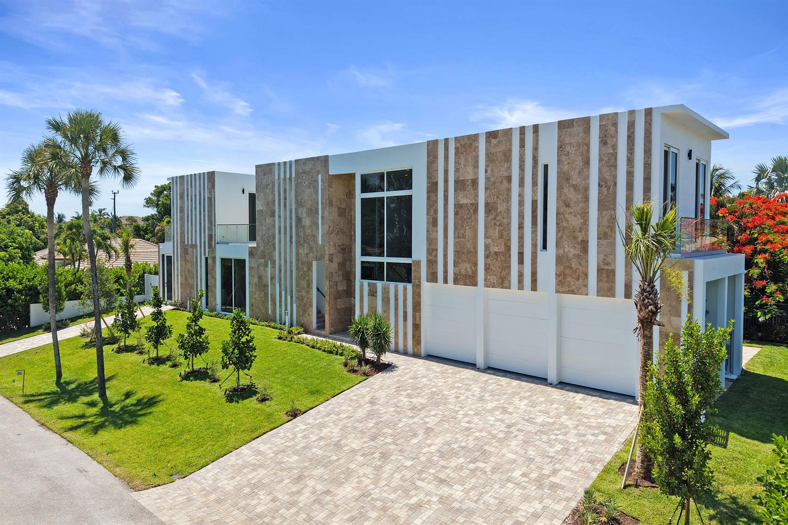A modern two-story house features a stone and white facade with a paved driveway — 824 W Marbella Lane, Lantana FL 33462, LANTANA, FL