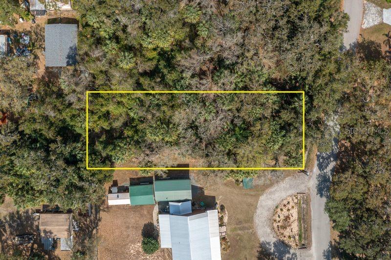 An aerial view shows a rectangular lot outlined in yellow, surrounded by dense trees — 00 W BEACH PARKWAY UNIT 0, LAKE WALES, FL