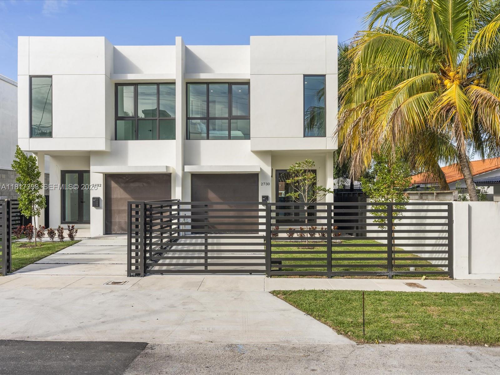 A small rectangular swimming pool with light stone decking sits in a fenced backyard — 2732 SW 31st Ave, Miami FL 33133, MIAMI, FL