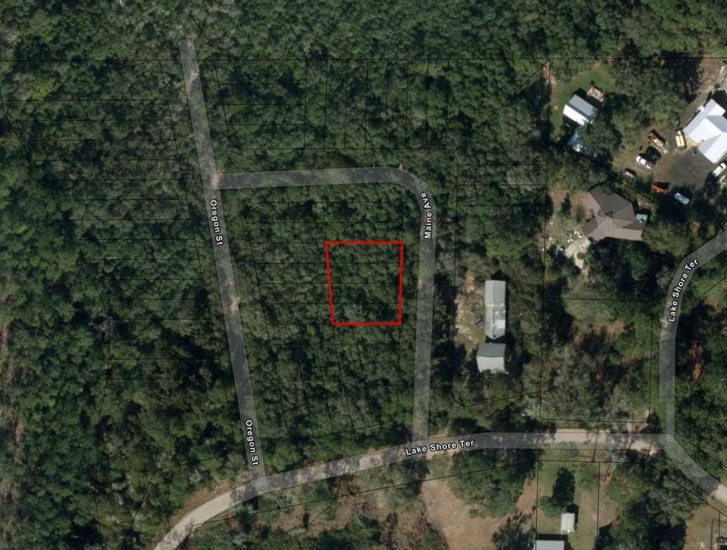 An aerial map shows a rectangular property lot outlined in red between two wooded streets — 0 Maine Avenue, FL 32148, FL