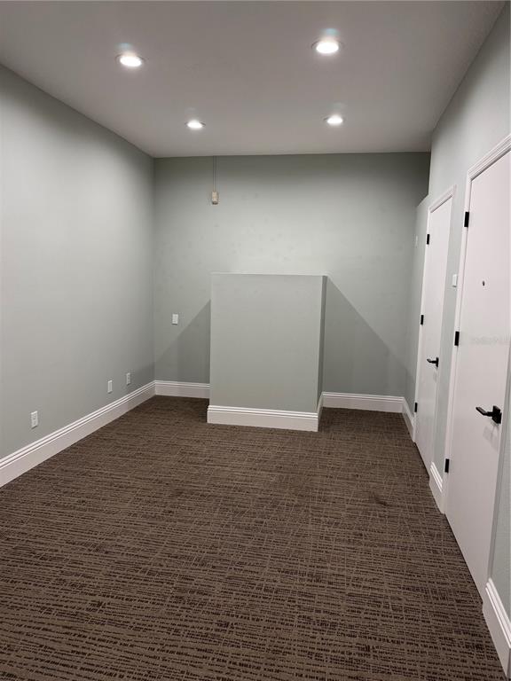 An empty room with light green walls, recessed lighting, and patterned brown carpet — 5182 N OCEAN SHORE BOULEVARD UNIT A-3, PALM COAST, FL