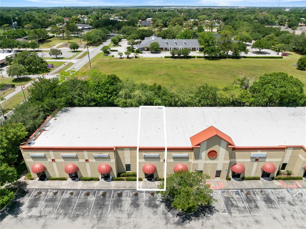 An aerial view shows a commercial building with a highlighted unit and parking lot — 3006 17TH STREET, ST CLOUD, FL