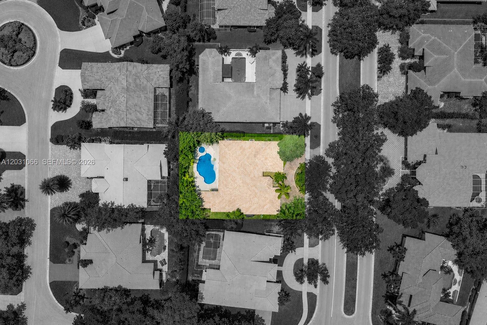 This aerial view shows a residential house with a pool surrounded by lush landscaping — 1776 W Eagle Trace Blvd W, Coral Springs FL 33071, CORAL SPRINGS, FL
