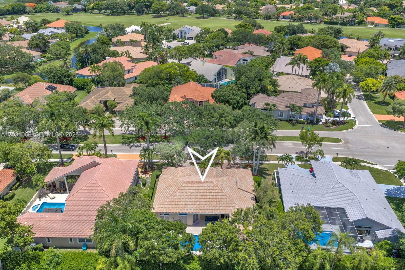 An aerial view shows a residential neighborhood with houses, swimming pools, and palm trees — 1776 W Eagle Trace Blvd W, Coral Springs FL 33071, CORAL SPRINGS, FL