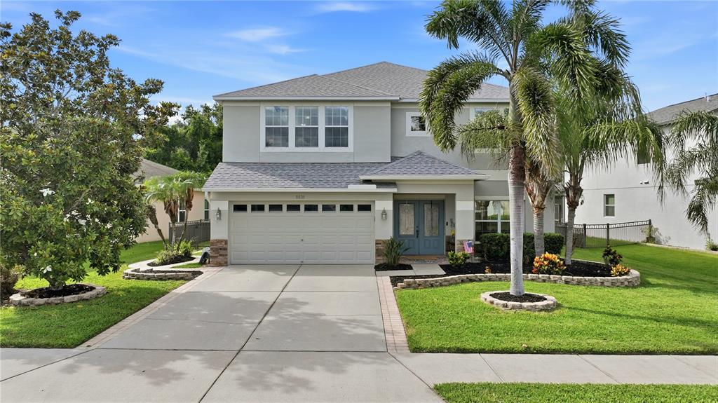A covered outdoor patio features a swimming pool, a fire pit, and wicker furniture — 8839 39TH STREET CIRCLE E, PARRISH, FL
