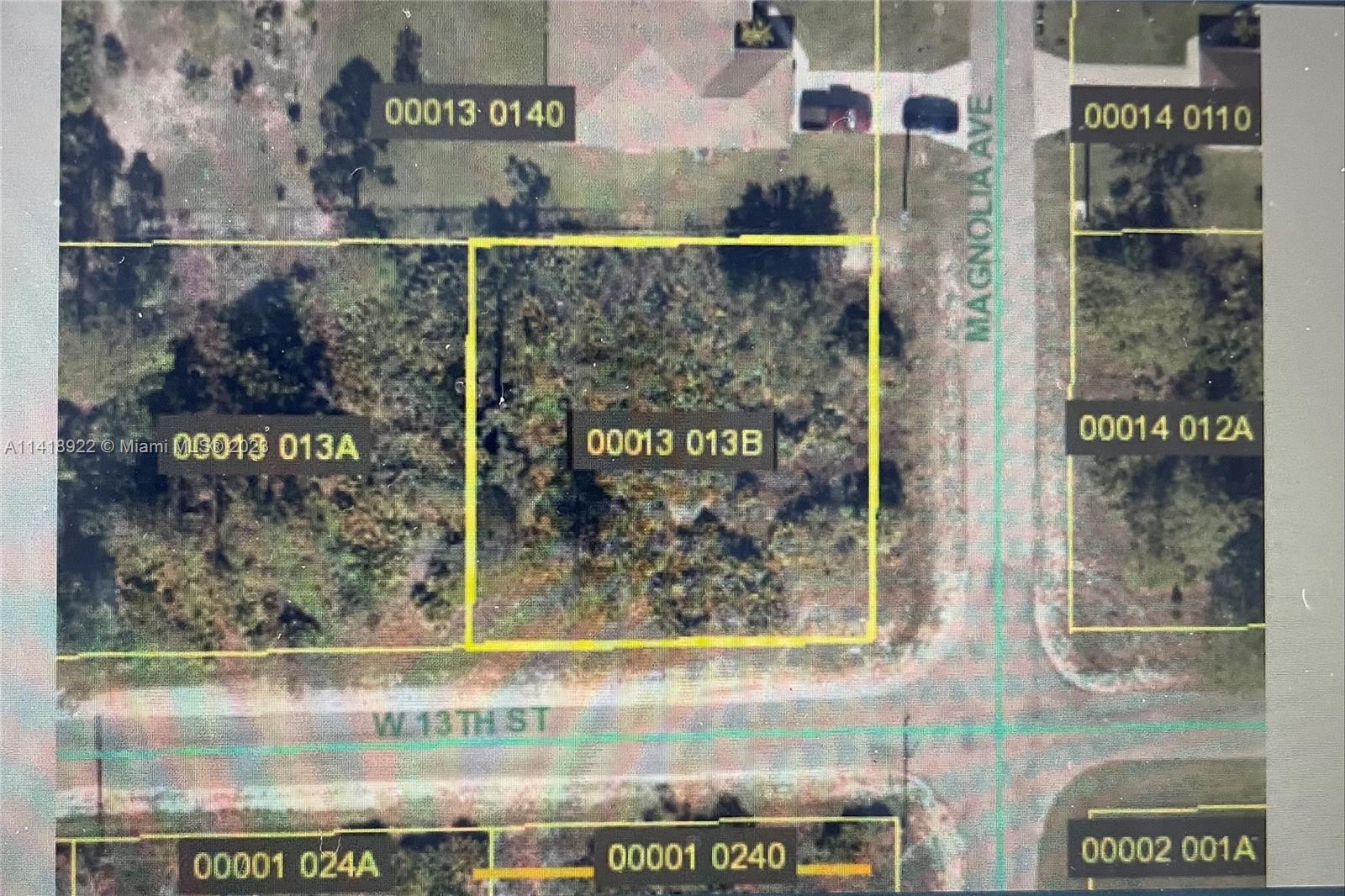 This is an aerial map showing a vacant lot highlighted in yellow at an intersection — 1000 W 13th ST, Lehigh Acres FL 33972, LEHIGH ACRES, FL