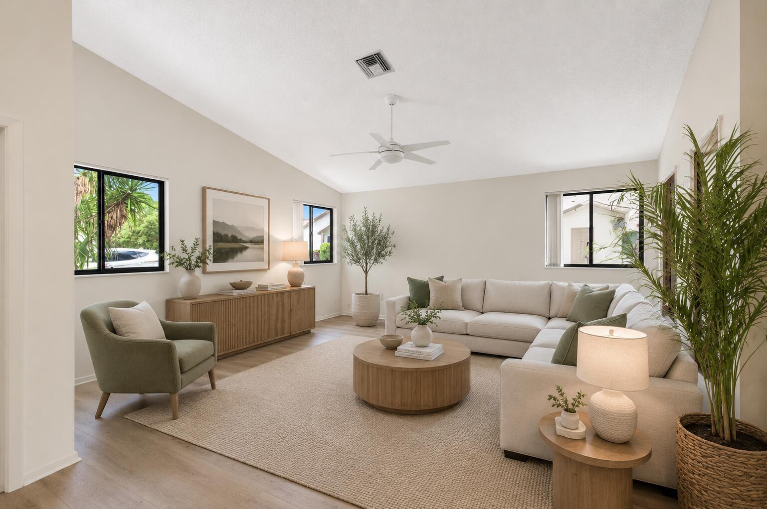 A bright living room features a sectional sofa, an armchair, and a wooden coffee table — 1320 NW 29th Avenue # D, Delray Beach FL 33445, DELRAY BEACH, FL