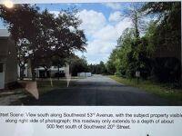 A view looking south down a paved street lined with trees and residential buildings — Na SW 20 Street, Ocala FL 34474, OCALA, FL