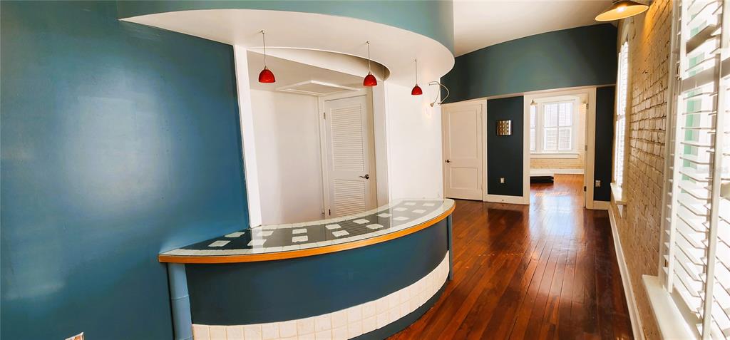 A curved bar with a tiled countertop sits in a room with blue walls and floors — 241 E PARK AVENUE, LAKE WALES, FL