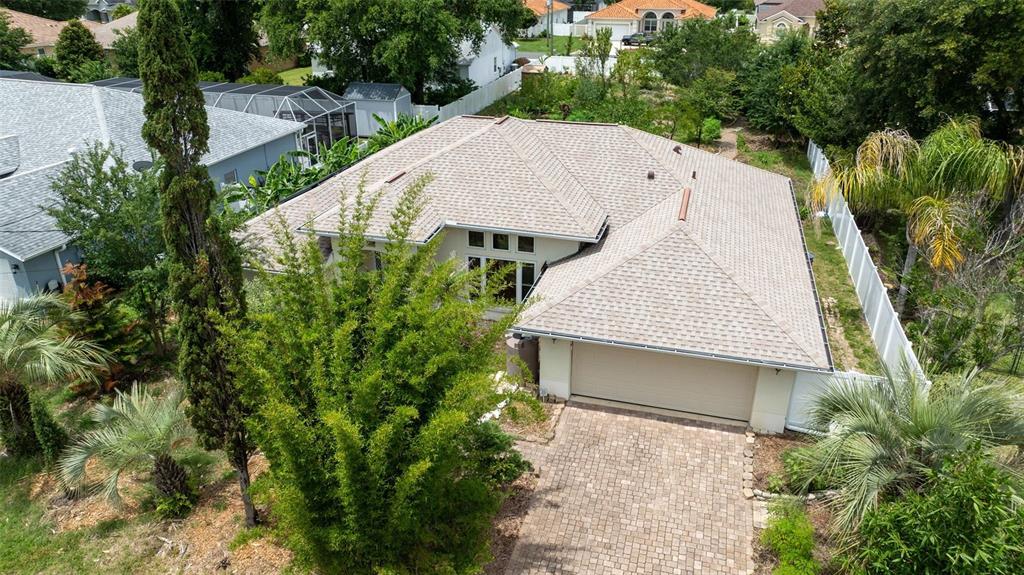 An aerial view shows a single-story house with a shingled roof and a paved driveway — 6 FAIRHILL LANE, PALM COAST, FL