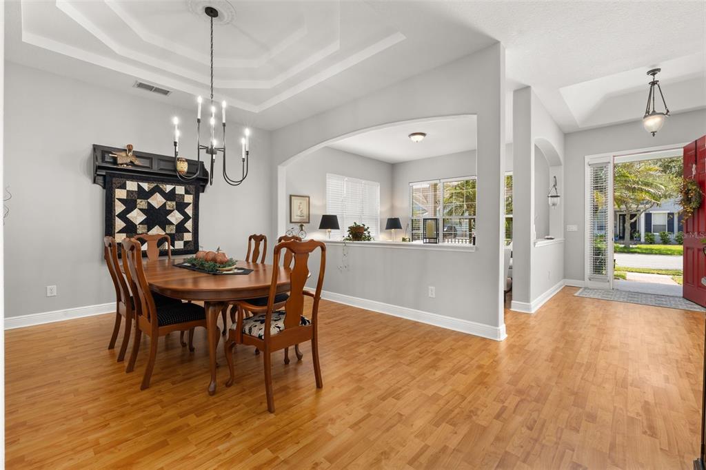 A covered front porch features a red door, two rocking chairs, and a small table — 14425 MAILER BOULEVARD, ORLANDO, FL