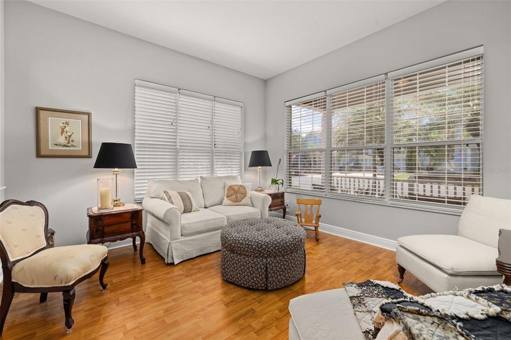 An entryway features a bright red front door, hardwood floors, and a decorative rug — 14425 MAILER BOULEVARD, ORLANDO, FL