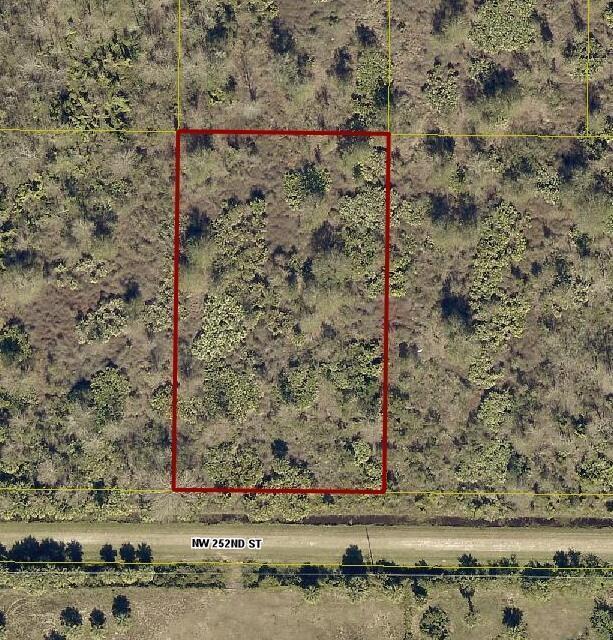 An aerial view shows a rectangular plot of land bordered by a road and vegetation — 15839 NW 252nd Street, Okeechobee FL 34972, OKEECHOBEE, FL