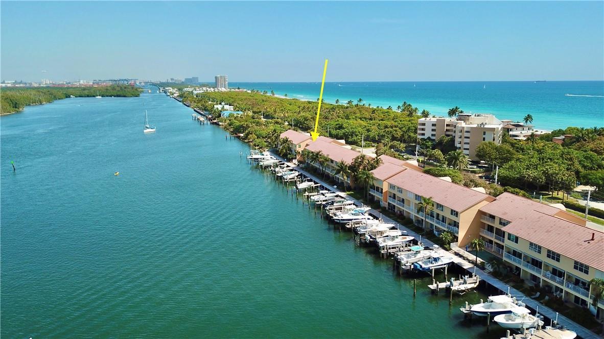 An aerial view shows a waterfront residential complex with boat slips along a canal — 4230 N Ocean Drive, Hollywood FL 33019, HOLLYWOOD, FL