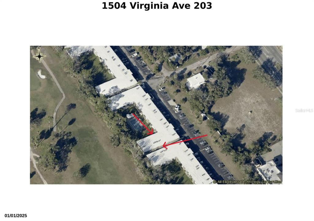 An aerial view shows a multi-unit residential building with red arrows pointing to a roof — 1504 VIRGINIA AVENUE UNIT 203, DAYTONA BEACH, FL