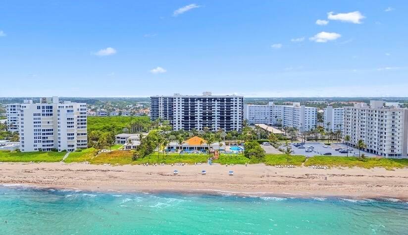 An aerial view of several multi-story apartment buildings situated along a sandy beach — 3400 S Ocean Boulevard, Highland Beach FL 33487, HIGHLAND BEACH, FL