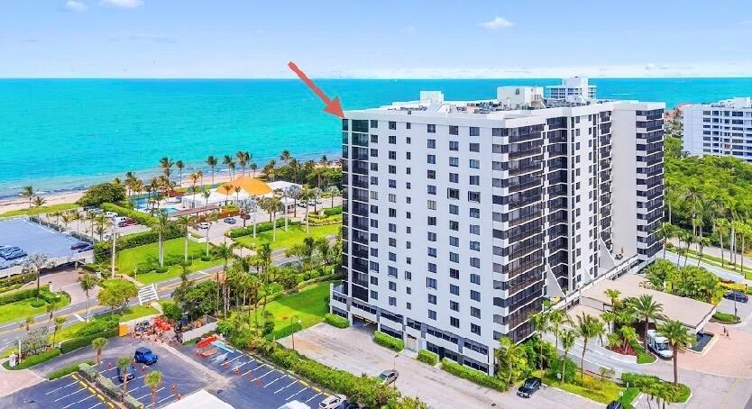 An aerial view of a tall white residential building located near a beach and ocean — 3400 S Ocean Boulevard, Highland Beach FL 33487, HIGHLAND BEACH, FL