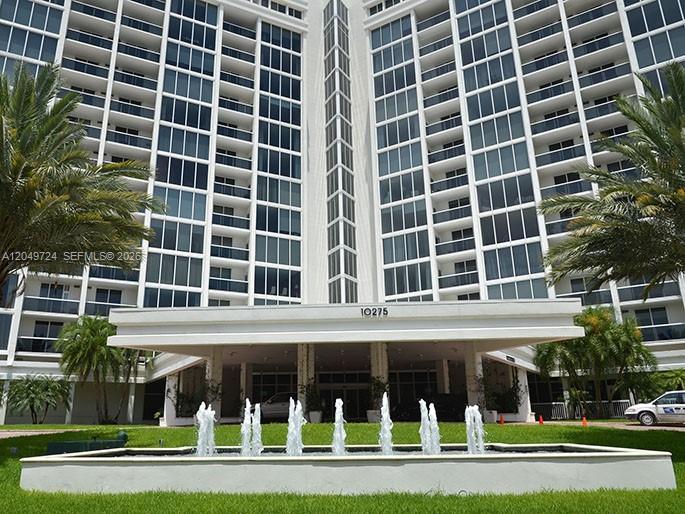 A multi-story residential building features a prominent entrance canopy and a front water fountain — 10275 Collins Ave # 335, Bal Harbour FL 33154, BAL HARBOUR, FL