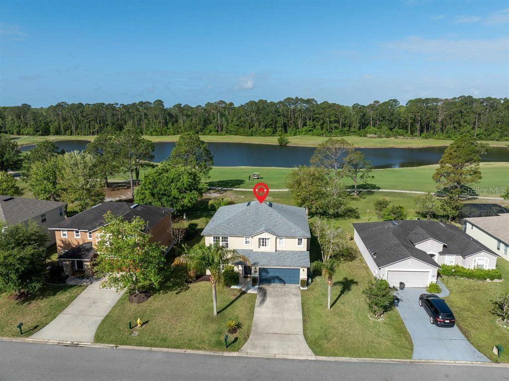 An aerial view of a two-story suburban house situated on a golf course — 5312 CYPRESS LINKS, ELKTON, FL