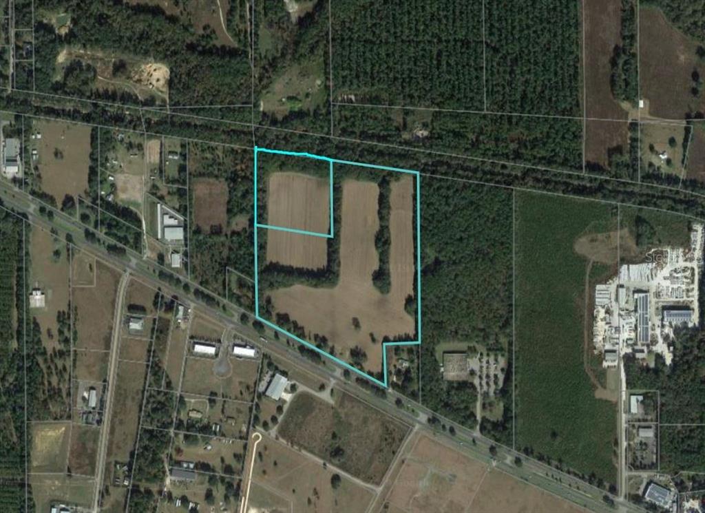 An aerial view shows a large, irregularly shaped plot of land outlined in light blue — TBD HIGHWAY 441, ALACHUA, FL