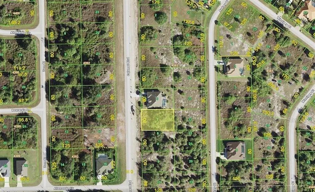 This is an aerial map showing a vacant residential lot highlighted in yellow — 9974 CALUMET BOULEVARD, PORT CHARLOTTE, FL
