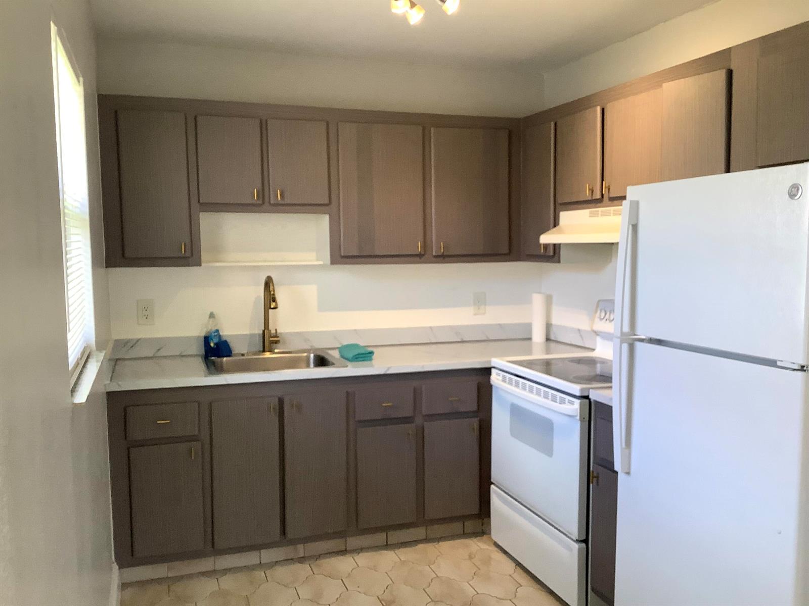 A kitchen with gray cabinets, white countertops, a stainless steel sink, and white appliances — 189 Saxony # 189, Delray Beach FL 33446, DELRAY BEACH, FL