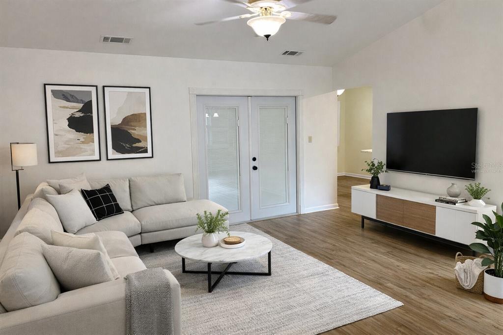 A living room features a light-colored sectional sofa, a marble coffee table, and a television — 4542 TIMBERLANE ROAD, LAKE WALES, FL