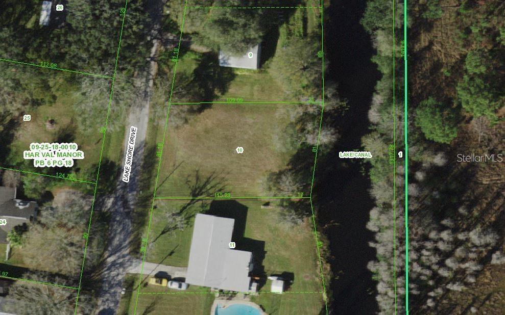 This is an aerial map showing a vacant residential lot situated between a road and a canal — 11124 LAKE SHORE DRIVE, LAND O LAKES, FL