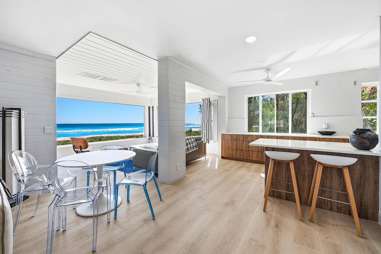 A modern kitchen and dining area with light wood floors and a view of the ocean — 2075 S Ocean Boulevard # 4b, Delray Beach FL 33483, DELRAY BEACH, FL