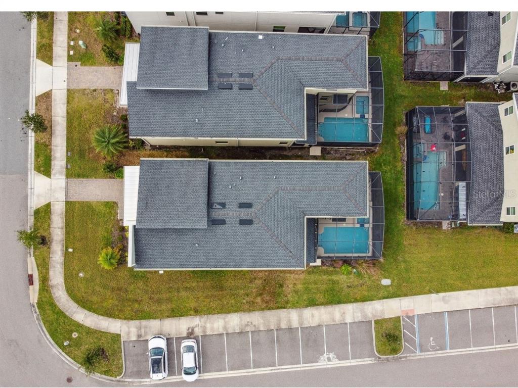 An aerial view shows two adjacent houses with private pools and a nearby parking lot — 2784 BOOKMARK DRIVE, KISSIMMEE, FL
